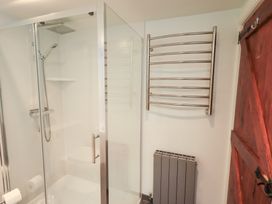 A bathroom with a shower and towel rail at Kiln How Threlkeld