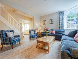 A living room with a coffee table and chairs at Home Farmhouse at the Graythwaite Estate near Hawkshead