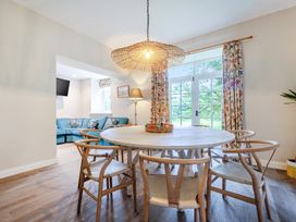 A dining room with a round table and chairs at Home Farmhouse at the Graythwaite Estate near Hawkshead