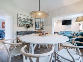 A dining room with a round table and chairs at Home Farmhouse at the Graythwaite Estate near Hawkshead