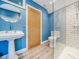 A bathroom with a sink, toilet, and shower at Home Farmhouse at the Graythwaite Estate near Hawkshead