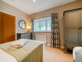 A bedroom with beds and furniture at Home Farmhouse at the Graythwaite Estate near Hawkshead