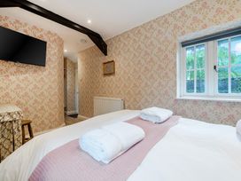 A bedroom with a bed and towels at Home Farmhouse at the Graythwaite Estate Graythwaite Estate near Hawkshead