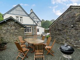 An outdoor dining area with a table and chairs at Home Farmhouse at the Graythwaite Estate near Hawkshead