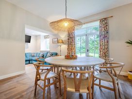 A dining area with a round table and chairs at Home Farmhouse at the Graythwaite Estate near Hawkshead