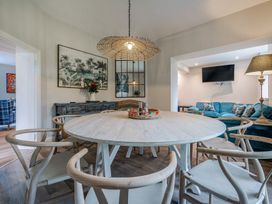 A dining room with a round table and chairs at Home Farmhouse at the Graythwaite Estate near Hawkshead