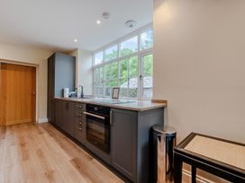 A kitchen with an oven and sink at Home Farmhouse at the Graythwaite Estate near Hawkshead