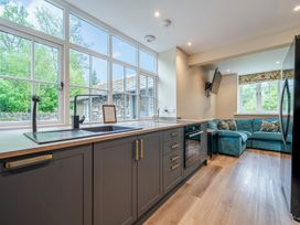 A kitchen with a sink and cooking area at Home Farmhouse at the Graythwaite Estate near Hawkshead