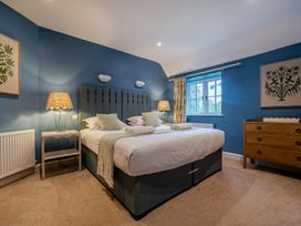 A bedroom with a bed and bedside table at Home Farmhouse at the Graythwaite Estate near Hawkshead