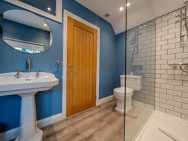 A bathroom with a sink and shower at Home Farmhouse at the Graythwaite Estate near Hawkshead