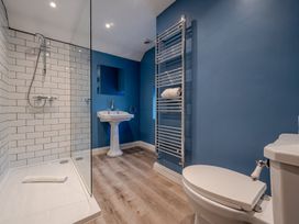 A bathroom with shower, sink, and toilet at Home Farmhouse at the Graythwaite Estate near Hawkshead
