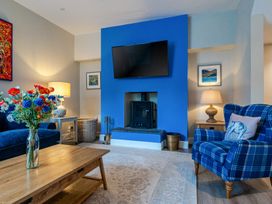 A living room with a sofa and television at Home Farmhouse at the Graythwaite Estate near Hawkshead
