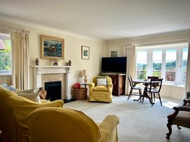 A living room with a television and a table at Samstone Donhead St. Mary near Ludwell