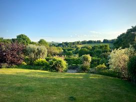 A garden with trees and bushes at Samstone Donhead St. Mary near Ludwell
