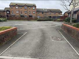 A parking lot with houses behind at Harbour View Poole