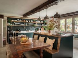 A kitchen with a dining table and kitchenware at Reybridge House in Lacock
