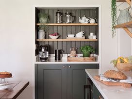 A kitchen with shelving units and various kitchen appliances at Reybridge House in Lacock