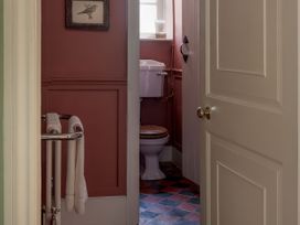 A bathroom with a toilet and towel rack at Reybridge House in Lacock