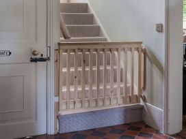 A staircase with a wooden gate and a door at Reybridge House in Lacock