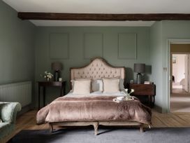 A bedroom with a bed and bedside tables at Reybridge House in Lacock