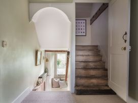 A hallway with a staircase and a window at Reybridge House in Lacock
