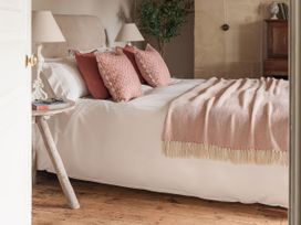 A bedroom with a bed and pillows at Reybridge House in Lacock