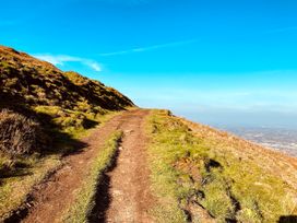 A path on a hillside under a clear blue sky at The Escape in Malvern