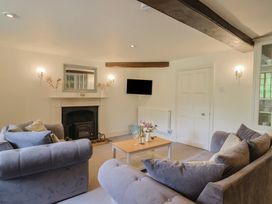 A living room with a fireplace and sofa at Garden View in Wellington