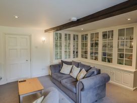 A living room with a couch and shelves at Garden View in Wellington