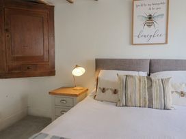 A bedroom with a bed and lamp at Garden View in Wellington
