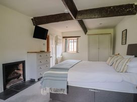A bedroom with a bed and fireplace at Garden View in Wellington