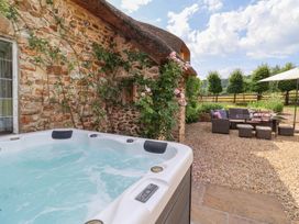 An outdoor area with a hot tub and seating arrangement at Garden View in Wellington