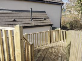 A deck area with railing and steps at Summer Rose in Craster