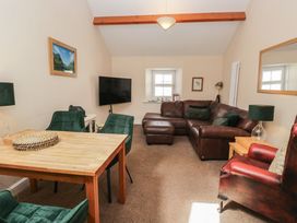 A living room with a sofa and dining table at Walkers Retreat in Keswick