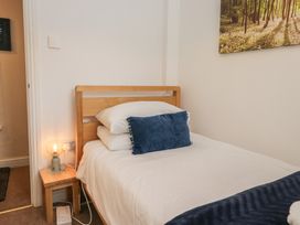 A bedroom with a bed and lamp at Walkers Retreat in Keswick