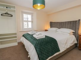 A bedroom with a bed and wardrobe at Walkers Retreat in Keswick