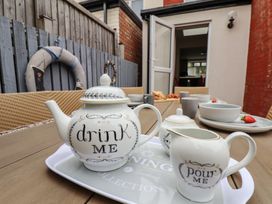 A teapot and milk jug on a tray with food at Over Esk in Whitby