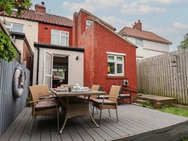 An outdoor dining area with a table and chairs at Over Esk in Whitby