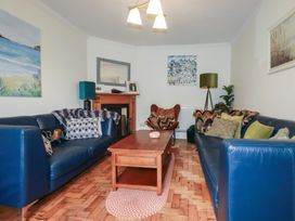 A living room with sofas and a coffee table at Trevethen Cottage in Crantock