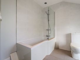 A bathroom with a bathtub and shower at Trevethen Cottage Crantock