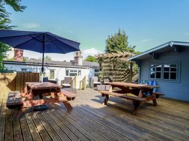 An outdoor seating area with a table and chairs at Trevethen Cottage in Crantock