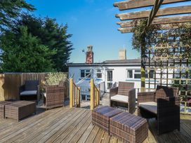 An outdoor area with seating and table at Trevethen Cottage in Crantock