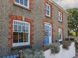 A house exterior with windows and a front door at Trevethen Cottage in Crantock