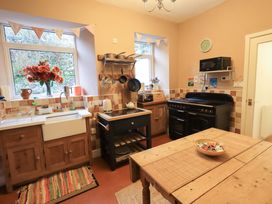 A kitchen with a sink and an oven at Yewbarrow Cottage in Grange-Over-Sands
