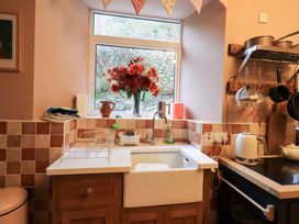 A kitchen with a sink and window at Yewbarrow Cottage in Grange-Over-Sands