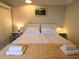 A bedroom with a bed and bedside tables at Yewbarrow Cottage Grange-Over-Sands