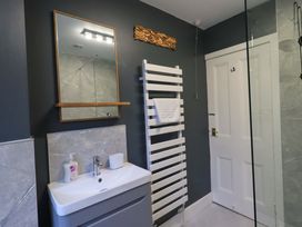 A bathroom with a vanity unit and towel radiator at Yewbarrow Cottage in Grange-Over-Sands