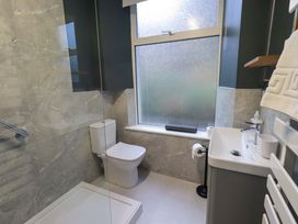 A bathroom with a shower, toilet, and sink at Yewbarrow Cottage in Grange-Over-Sands