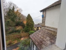 A view of trees and a house from a property at Yewbarrow Cottage Grange-Over-Sands