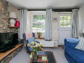 A living room with a television and sofa at 3 Rock Cottages in Kingston